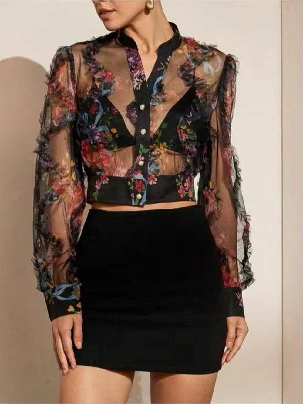 Black floral mesh blouse with ruffled sleeves and button-up front